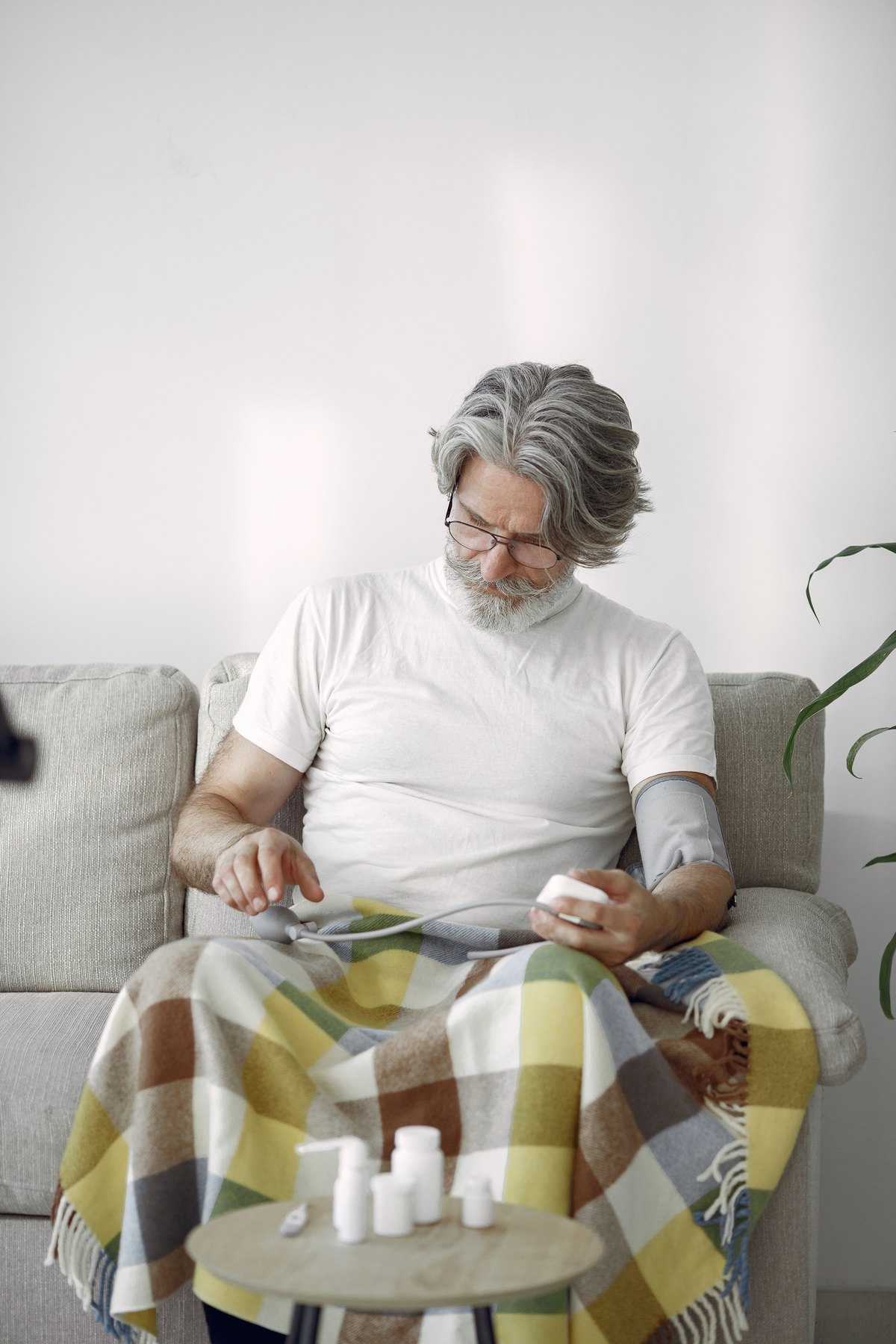 A person using a home blood-pressure monitor as part of an ongoing health routine