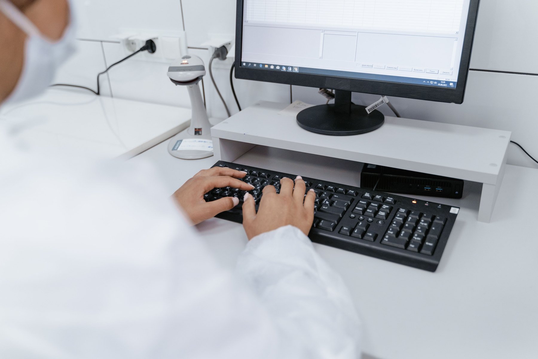 A healthcare professional using a computer in a clinical administration environment